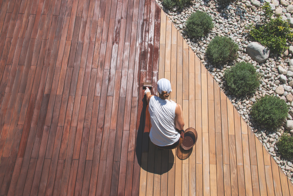 Wood,Deck,Renovation,Treatment,,The,Person,Applying,Protective,Wood,Stain