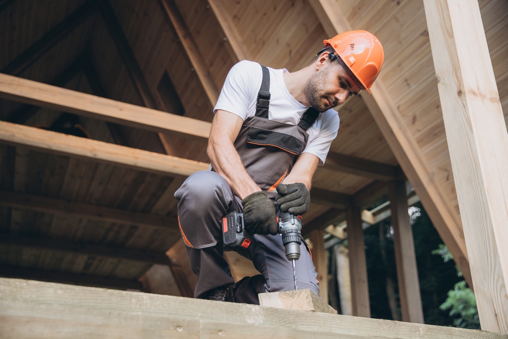 Construction,Worker,Working,With,Screwdriver,On,Wooden,Frame,,Diy,Eco friendly